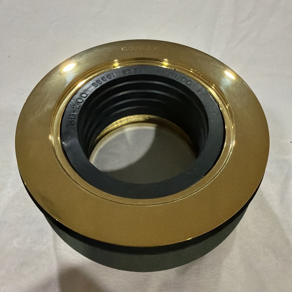 Kohler‎ K-9132 round shower drain with a gasket in a polished brass finish.